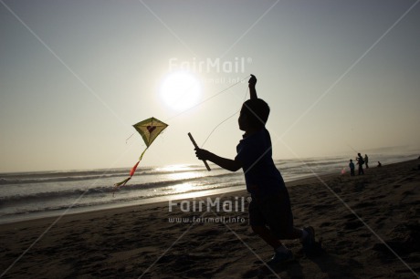 Fair Trade Photo Activity, Backlit, Beach, Colour image, Evening, Freedom, Heart, Kite, Love, One boy, Outdoor, People, Peru, Playing, Sea, Silhouette, Sky, South America, Summer, Sunset, Water