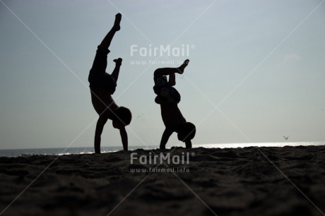 Fair Trade Photo Activity, Backlit, Beach, Colour image, Cooperation, Doing handstand, Evening, Friendship, Outdoor, People, Peru, Sand, Silhouette, South America, Summer, Together, Two boys, Yoga
