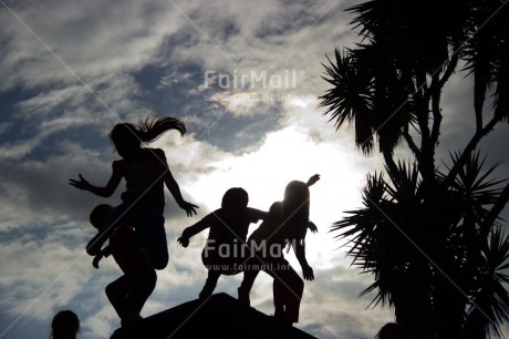 Fair Trade Photo Activity, Backlit, Clouds, Colour image, Friendship, Group of children, Jumping, Palmtree, People, Peru, Playing, Silhouette, Sky, South America, Together, Tree