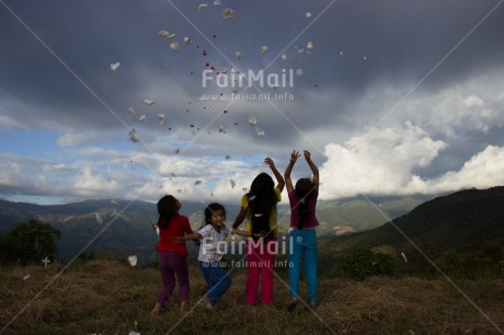 Fair Trade Photo 5 -10 years, Activity, Backlit, Clouds, Colour image, Cooperation, Emotions, Evening, Flower, Friendship, Group of girls, Happiness, Latin, Mountain, Outdoor, People, Peru, Playing, Rural, Silhouette, Sky, South America, Throwing, Together