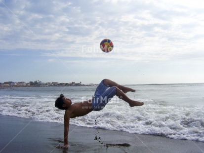 Fair Trade Photo Activity, Ball, Beach, Colour image, Day, Horizontal, Jumping, One boy, Outdoor, People, Peru, Sea, Seasons, South America, Sport, Strength, Summer, Water