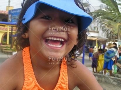 Fair Trade Photo 5-10 years, Activity, Beach, Blue, Colour image, Cute, Day, Emotions, Food and alimentation, Fruits, Happiness, Horizontal, Latin, Looking at camera, One girl, Orange, Outdoor, People, Peru, Portrait headshot, Seasons, Sitting, Smile, Smiling, South America, Streetlife, Summer