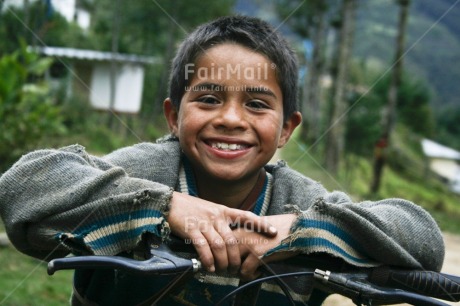 Fair Trade Photo 5 -10 years, Activity, Bicycle, Colour image, Horizontal, Latin, Looking at camera, One boy, People, Peru, Portrait halfbody, Rural, Smile, Smiling, South America, Transport