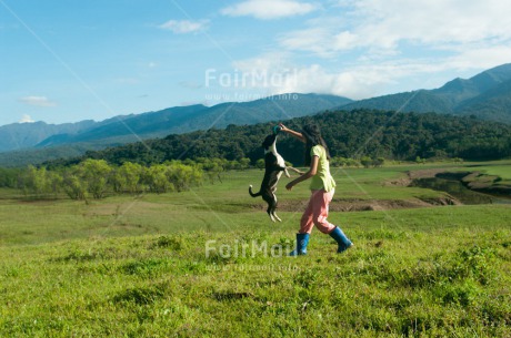 Fair Trade Photo Activity, Animals, Ball, Colour image, Day, Dog, Emotions, Friendship, Happiness, Horizontal, Jumping, Mountain, One girl, Outdoor, People, Peru, Playing, Rural, Smiling, South America, Together