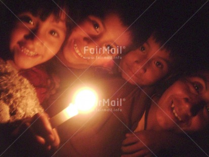 Fair Trade Photo 5-10 years, Activity, Candle, Christmas, Colour image, Family, Flame, Good luck, Group of children, Horizontal, Indoor, Looking at camera, Night, People, Peru, South America, Strength, Thinking of you, Together