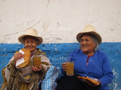 Fair Trade Photo 55-60 years, Activity, Day, Eating, Ethnic-folklore, Food and alimentation, Friendship, Health, Horizontal, Latin, Outdoor, People, Portrait halfbody, Rural, Sombrero, Streetlife, Together, Two women