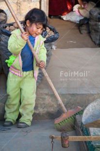 Fair Trade Photo 5 -10 years, Activity, Casual clothing, Child labour, Cleaning, Clothing, Colour image, Dailylife, Day, Latin, Market, One girl, Outdoor, People, Peru, Rural, South America, Sweeping, Vertical
