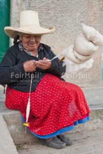 Fair Trade Photo Activity, Clothing, Colour image, Day, Hat, Knitting, Latin, Market, One woman, Outdoor, People, Peru, Rural, Sitting, Sombrero, South America, Traditional clothing, Vertical, Wool