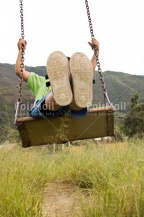 Fair Trade Photo 5 -10 years, Activity, Colour image, Grass, Latin, Low angle view, One child, Outdoor, People, Peru, Playing, Rural, South America, Swing, Vertical