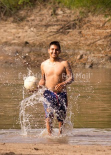 Fair Trade Photo Activity, Ball, Colour image, Day, Health, One boy, Outdoor, People, Peru, Playing, River, Soccer, South America, Sport, Vertical