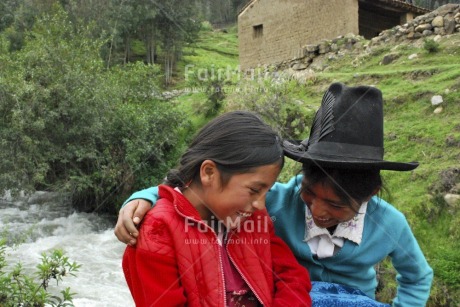 Fair Trade Photo Clothing, Colour image, Dailylife, Ethnic-folklore, Friendship, Hat, Horizontal, Hug, Multi-coloured, Nature, Outdoor, People, Peru, Portrait halfbody, Rural, Smile, Smiling, South America, Streetlife, Together, Two children, Two girls