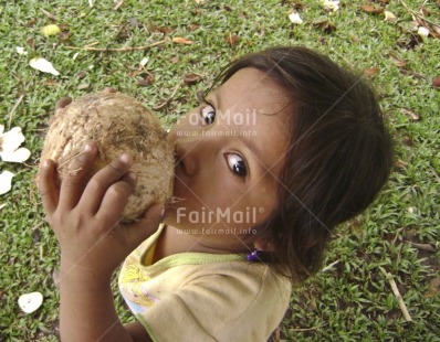 Fair Trade Photo Activity, Coconut, Colour image, Cute, Drinking, Food and alimentation, Girl, Green, Horizontal, Looking at camera, Nature, One child, One girl, Outdoor, People, Peru, Portrait halfbody, South America