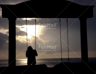 Fair Trade Photo Activity, Backlit, Beach, Colour image, Emotions, Evening, Horizontal, One girl, Outdoor, People, Peru, Sadness, Sea, Silhouette, Sitting, Sky, South America, Sunset, Swing, Thinking of you, Water