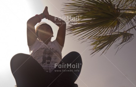 Fair Trade Photo 15-20 years, Activity, Casual clothing, Clothing, Colour image, Horizontal, Latin, Light, Low angle view, Meditating, One girl, People, Peru, Sitting, South America, Sun, Tree, Yoga