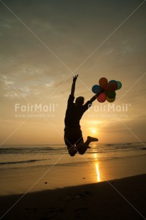 Fair Trade Photo Activity, Backlit, Balloon, Beach, Birthday, Colour image, Evening, Invitation, Jumping, One girl, Outdoor, Party, People, Peru, Sand, Silhouette, South America, Sunset, Vertical, Water