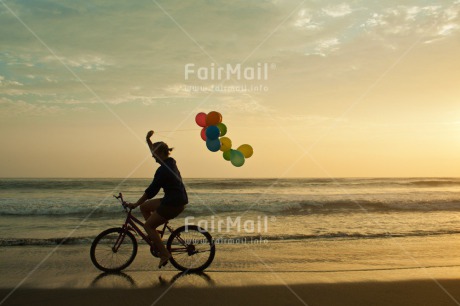 Fair Trade Photo Backlit, Balloon, Beach, Bicycle, Birthday, Colour image, Evening, Horizontal, Invitation, One girl, Outdoor, Party, People, Peru, Sand, Silhouette, South America, Sunset, Transport, Water