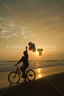 Fair Trade Photo Backlit, Balloon, Beach, Bicycle, Birthday, Colour image, Evening, Invitation, One girl, Outdoor, Party, People, Peru, Sand, Silhouette, South America, Sunset, Transport, Vertical, Water