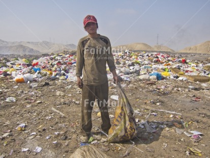 Fair Trade Photo 20-25 years, Activity, Casual clothing, Child labour, Clothing, Colour image, Day, Garbage, Health, Hygiene, Looking at camera, One boy, Outdoor, People, Peru, Portrait fullbody, Recycle, Safety, Sanitation, South America, Standing, Vertical, Working