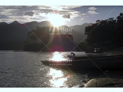 Fair Trade Photo Backlit, Boat, Colour image, Evening, Fisherman, Horizontal, Mountain, Nature, One man, Outdoor, People, Peru, Reflection, River, Rural, Scenic, Silhouette, South America, Sun, Sunset, Travel, Water