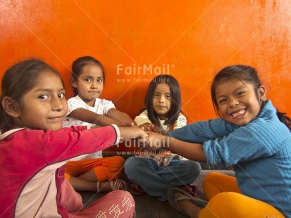 Fair Trade Photo 5-10 years, Activity, Casual clothing, Clothing, Colour image, Cooperation, Day, Education, Friendship, Group of girls, Horizontal, Indoor, Looking at camera, People, Peru, Playing, Portrait halfbody, School, Sitting, Smiling, South America, Together