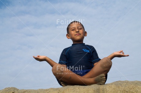 Fair Trade Photo Activity, Beach, Colour image, Day, Horizontal, Meditating, One boy, Outdoor, People, Peru, Relaxing, Sand, Sitting, South America, Spirituality, Yoga